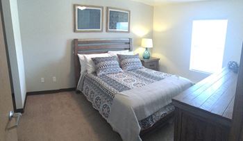 a bedroom with a bed and a dresser
